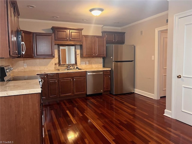 kitchen featuring dark hardwood / wood-style flooring, tasteful backsplash, crown molding, stainless steel appliances, and sink