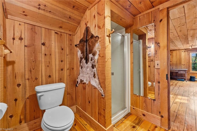 bathroom featuring wooden walls, hardwood / wood-style floors, wooden ceiling, and an enclosed shower