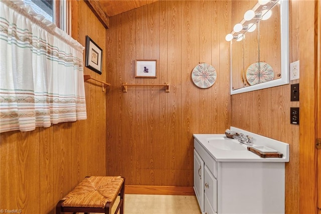 bathroom with wood walls and vanity