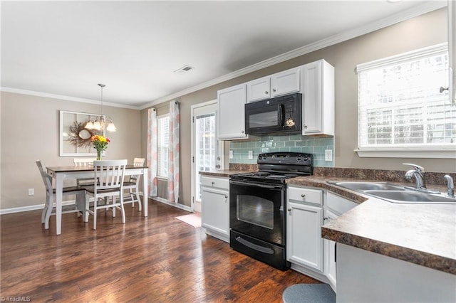 kitchen with decorative light fixtures, sink, white cabinets, and black appliances