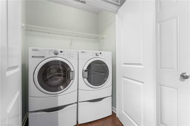 laundry room featuring dark wood-type flooring and independent washer and dryer