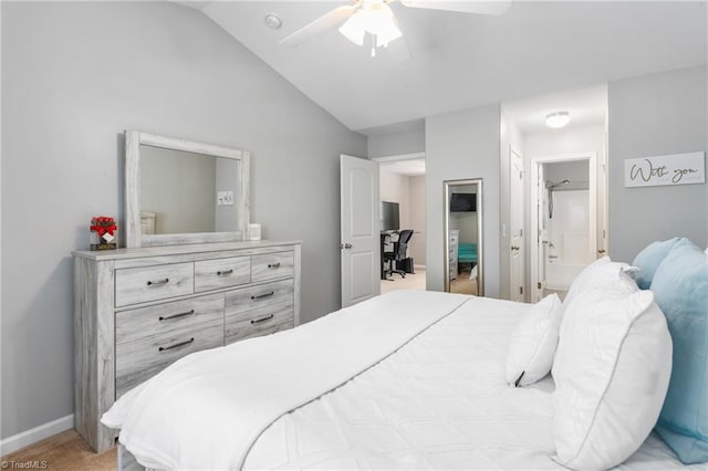 bedroom featuring ceiling fan, ensuite bathroom, and lofted ceiling