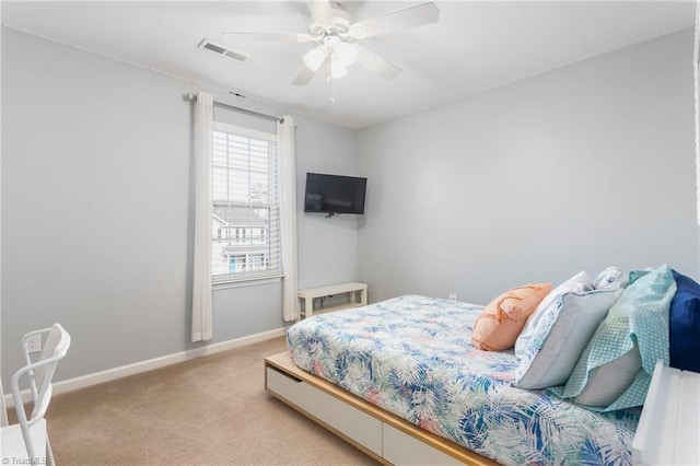 bedroom with ceiling fan and light colored carpet