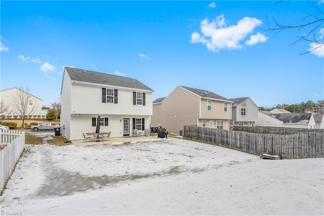 view of snow covered rear of property