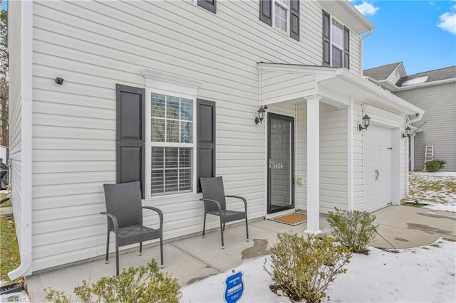 doorway to property with a garage