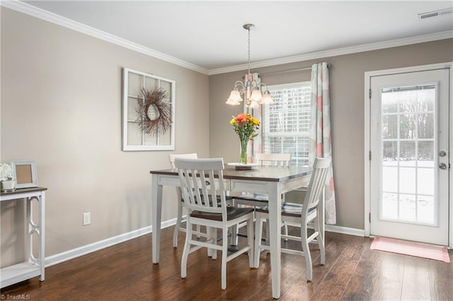 dining room featuring an inviting chandelier, dark hardwood / wood-style flooring, and crown molding