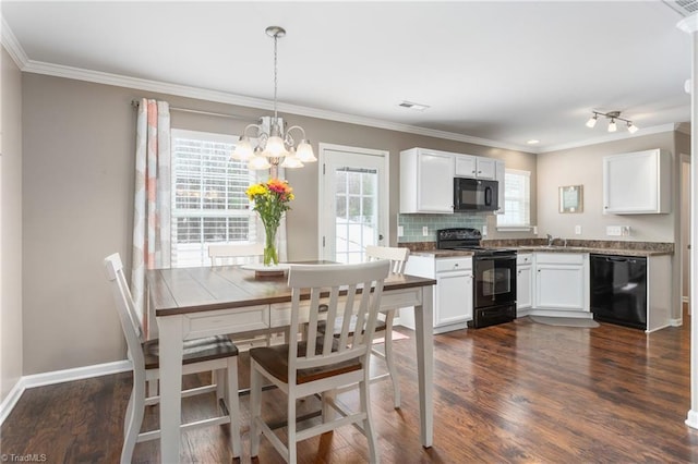 kitchen featuring white cabinetry, backsplash, decorative light fixtures, and black appliances