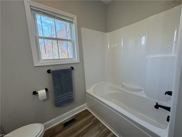 bathroom with hardwood / wood-style floors and toilet