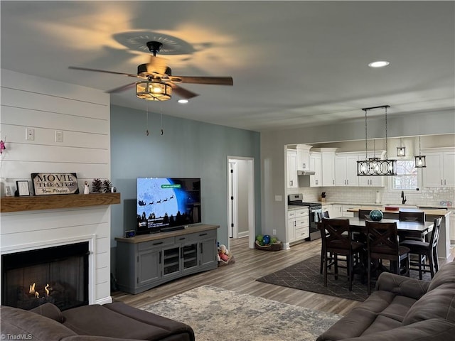 living room with ceiling fan and hardwood / wood-style flooring