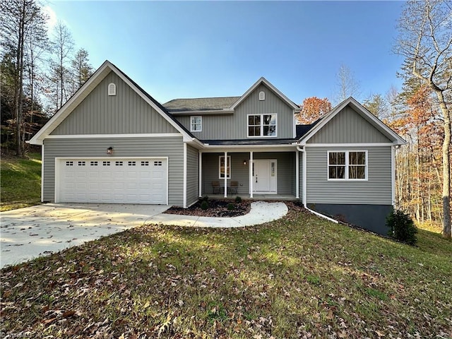 view of front of home featuring a porch, a garage, and a front yard