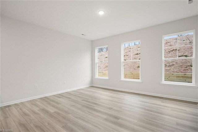 5365 Roshni Ter, Mcleansville, NC 27301 - spare room featuring light wood-style floors and baseboards
