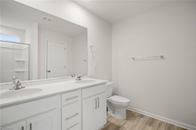 5365 Roshni Ter, Mcleansville, NC 27301 - full bath featuring toilet, wood finished floors, a sink, and visible vents