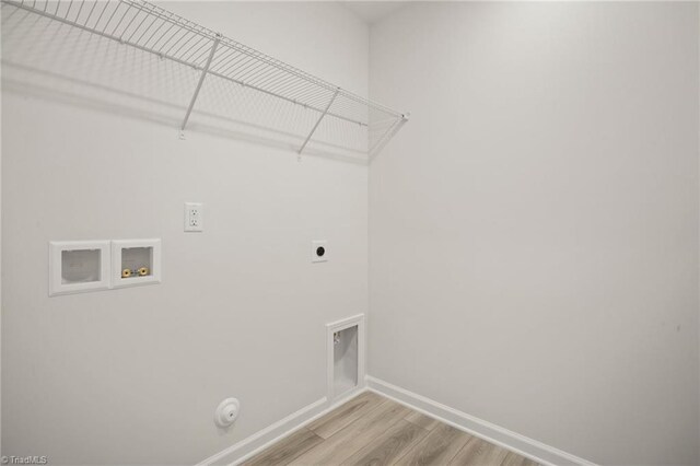 5365 Roshni Ter, Mcleansville, NC 27301 - washroom featuring electric dryer hookup, gas dryer hookup, light wood-style flooring, washer hookup, and laundry area