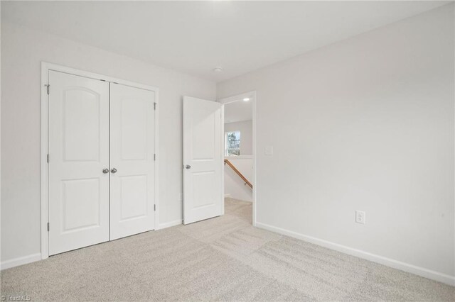 5365 Roshni Ter, Mcleansville, NC 27301 - unfurnished bedroom featuring a closet, carpet flooring, and baseboards