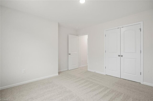 5365 Roshni Ter, Mcleansville, NC 27301 - unfurnished bedroom featuring a closet, carpet, and baseboards