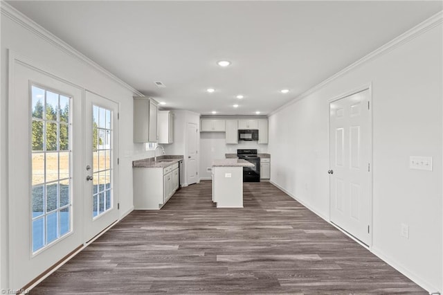 kitchen with dark wood-style flooring, recessed lighting, french doors, crown molding, and black appliances