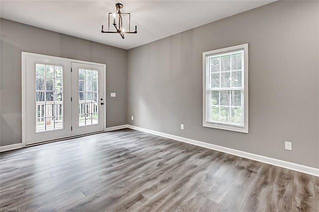 307 Lick Creek Church Rd, Denton, NC 27239 - unfurnished room with wood finished floors, a chandelier, and baseboards