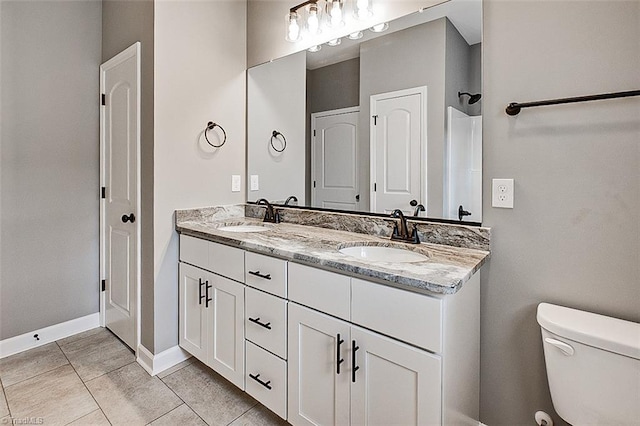 307 Lick Creek Church Rd, Denton, NC 27239 - full bathroom with double vanity, toilet, tile patterned floors, and baseboards