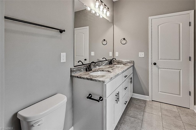 307 Lick Creek Church Rd, Denton, NC 27239 - bathroom featuring double vanity, toilet, baseboards, and tile patterned flooring