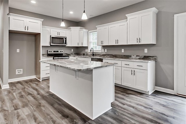 307 Lick Creek Church Rd, Denton, NC 27239 - kitchen with stainless steel appliances, white cabinetry, recessed lighting, a kitchen island, and light stone countertops