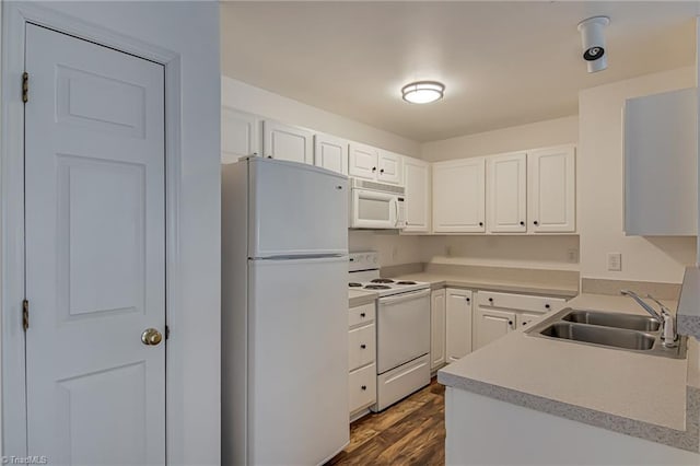 kitchen with white appliances, dark wood-style flooring, a sink, light countertops, and white cabinetry