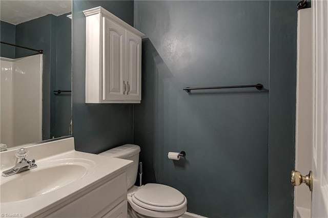 full bath featuring vanity, toilet, and a shower