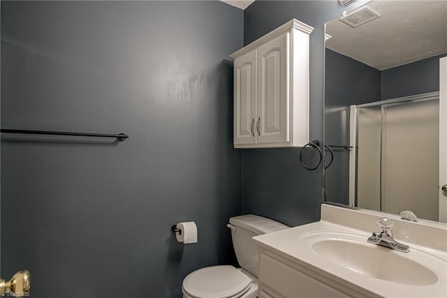 bathroom featuring visible vents, toilet, and vanity