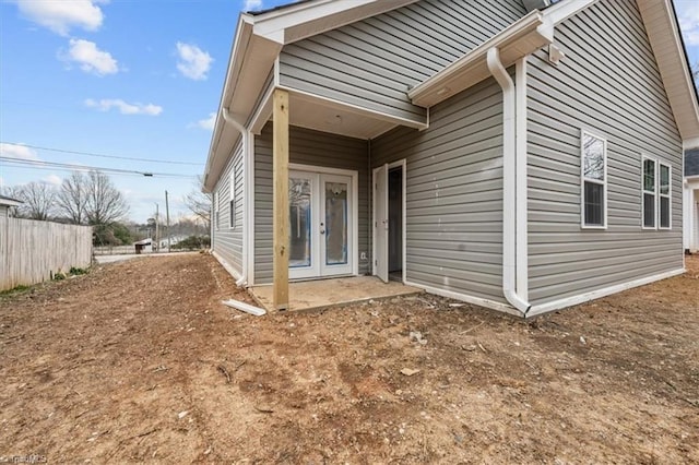 exterior space featuring fence and french doors