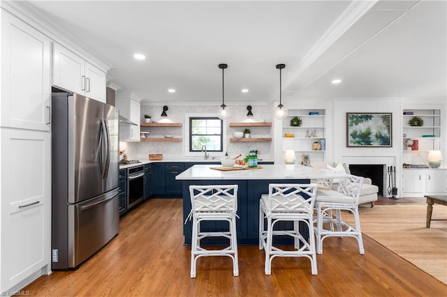 306 W Greenway Dr S, Greensboro, NC 27403 - kitchen with stainless steel appliances, open shelves, a sink, ornamental molding, and light countertops