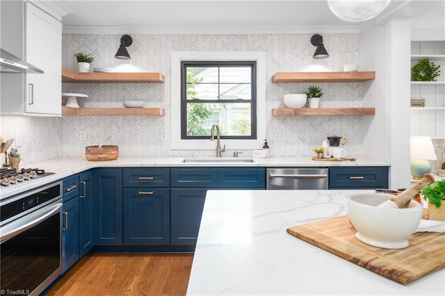 306 W Greenway Dr S, Greensboro, NC 27403 - kitchen featuring appliances with stainless steel finishes, a sink, open shelves, blue cabinets, and crown molding