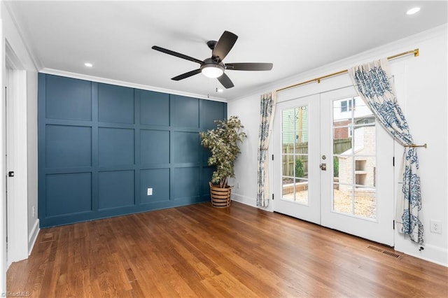306 W Greenway Dr S, Greensboro, NC 27403 - spare room with a decorative wall, french doors, ornamental molding, ceiling fan, and wood finished floors