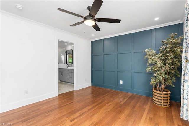 306 W Greenway Dr S, Greensboro, NC 27403 - spare room with a decorative wall, a ceiling fan, ornamental molding, wood finished floors, and recessed lighting