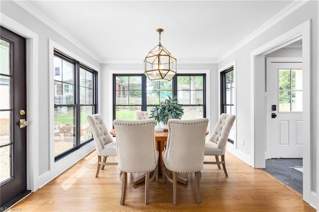 306 W Greenway Dr S, Greensboro, NC 27403 - dining area featuring plenty of natural light, a chandelier, light wood finished floors, ornamental molding, and baseboards