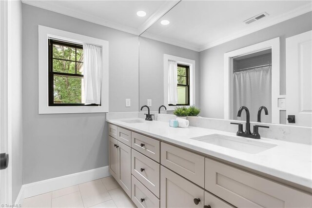 306 W Greenway Dr S, Greensboro, NC 27403 - bathroom with double vanity, baseboards, crown molding, and tile patterned flooring