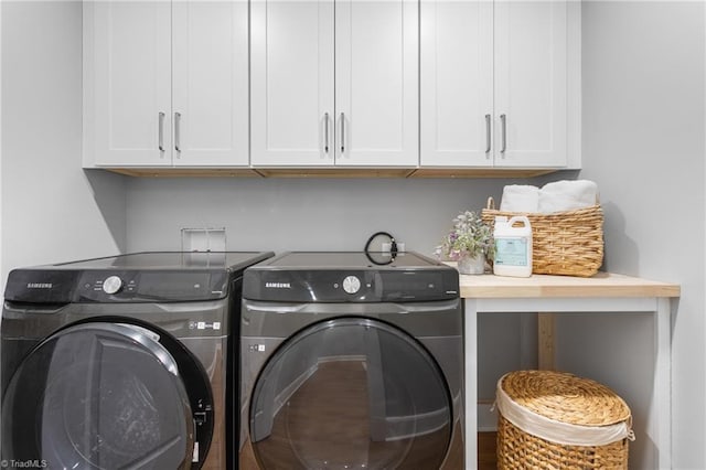 306 W Greenway Dr S, Greensboro, NC 27403 - laundry room featuring washing machine and clothes dryer and cabinet space