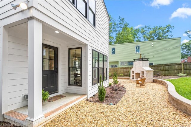 306 W Greenway Dr S, Greensboro, NC 27403 - fenced backyard with a fireplace