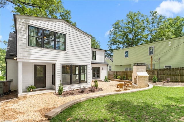 306 W Greenway Dr S, Greensboro, NC 27403 - rear view of house featuring a fireplace and a patio area
