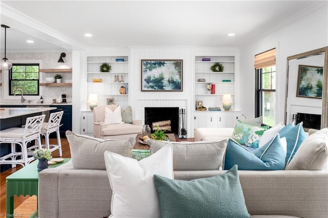 306 W Greenway Dr S, Greensboro, NC 27403 - living room featuring a brick fireplace, crown molding, healthy amount of natural light, wood finished floors, and recessed lighting