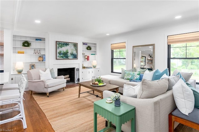 306 W Greenway Dr S, Greensboro, NC 27403 - living room featuring light wood finished floors, a fireplace, built in features, recessed lighting, and ornamental molding
