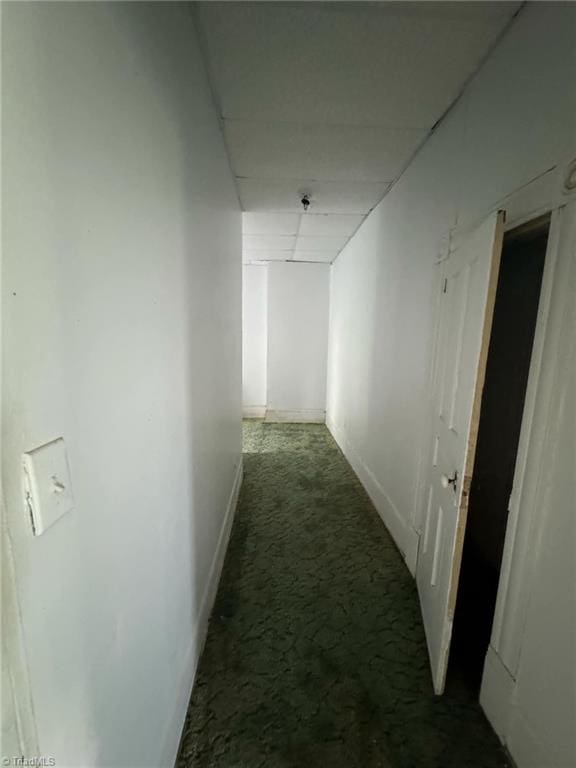 corridor with dark colored carpet