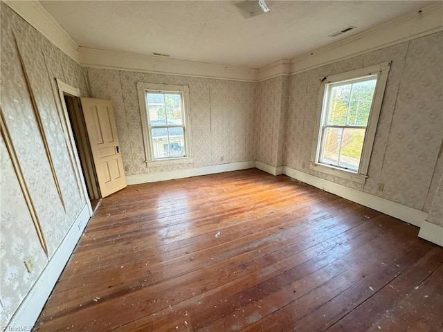 unfurnished bedroom with ornamental molding and hardwood / wood-style flooring