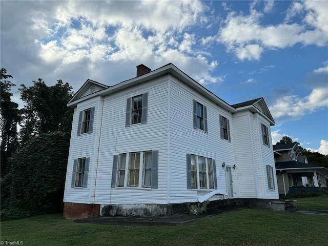 view of property exterior with a yard