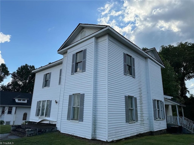 view of property exterior with a lawn