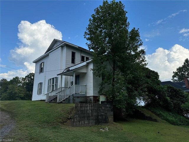 back of property featuring a yard