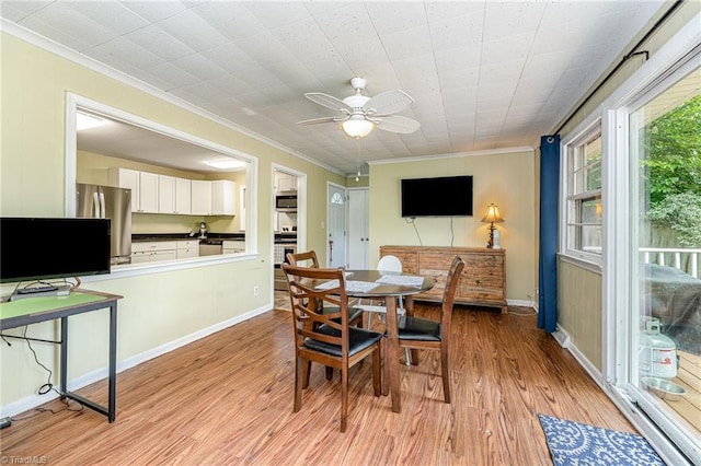 dining area featuring ornamental molding, ceiling fan, baseboards, and light wood-style floors