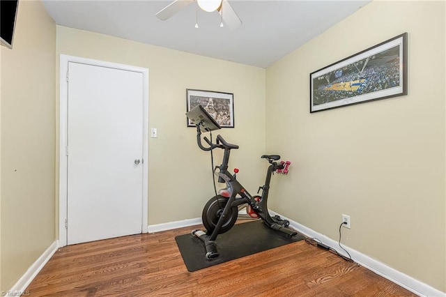 exercise room featuring baseboards, wood finished floors, and ceiling fan