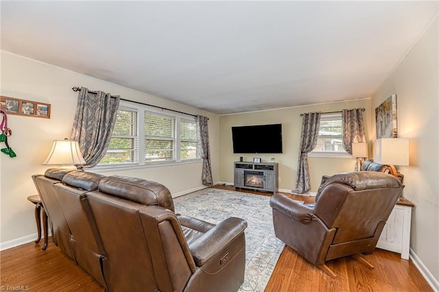 living area with wood finished floors and baseboards