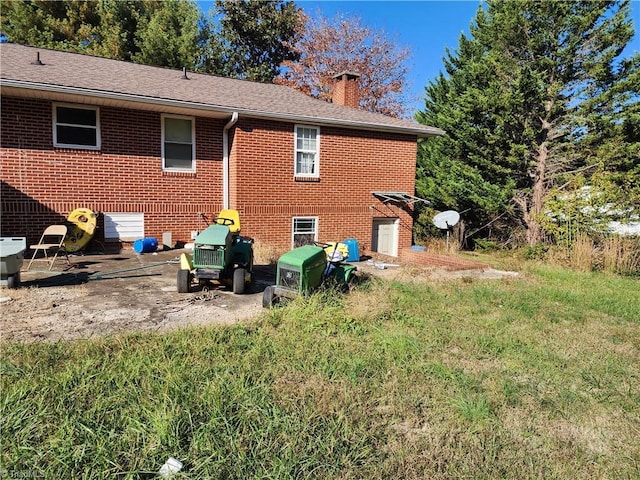 rear view of property featuring a lawn