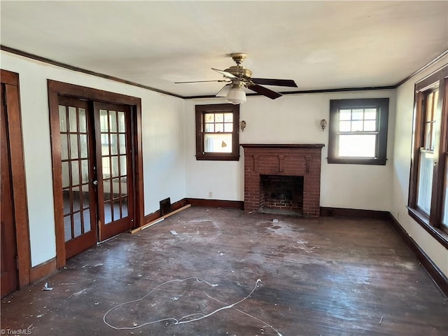 unfurnished living room with crown molding, a brick fireplace, and french doors