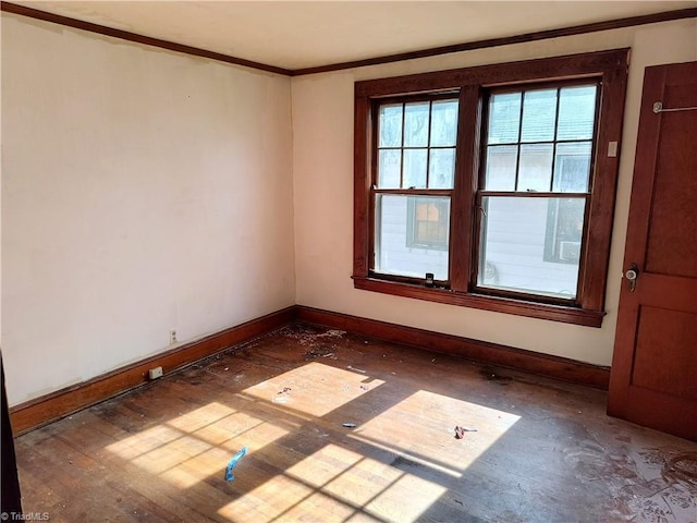 unfurnished room featuring dark wood-type flooring and ornamental molding